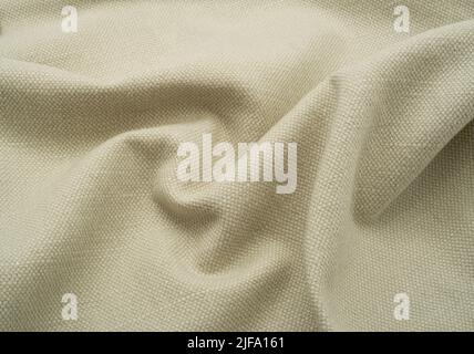 Textured fabric background. A natural cream linen. Stock Photo