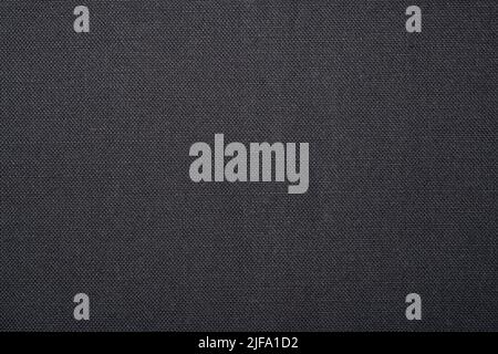 Textured fabric background. A plain grey flat background with woven textured surface. Stock Photo