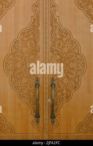 Tashkent, Uzbekistan. December 2021. Wooden carved beautiful doors in the architecture of the city Stock Photo