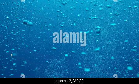 Air bubbles floating from sea bottom to the water surface. Air bubbles in the blue water. Mediterranean Sea, Cyprus Stock Photo