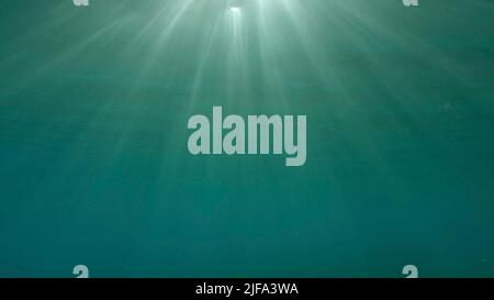 Sunrays penetrate through the surface of the water. Underwater light creates a beautiful veil, consisting of sunlight. range rays of the sun at Stock Photo