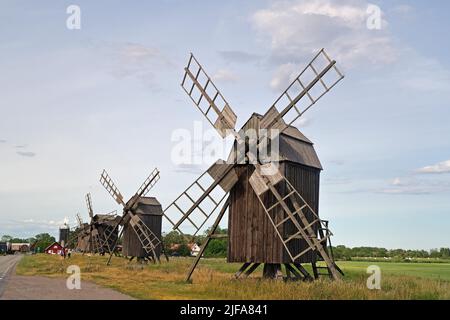 Several wooden mills standing by a road, Lerkaka, Oeland, Sweden Stock Photo