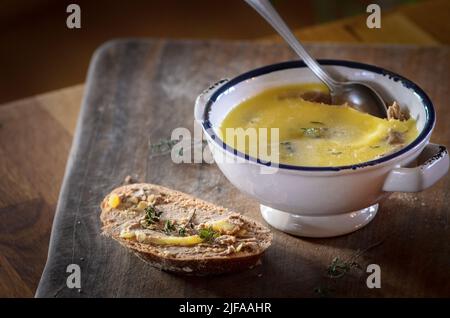Chicken Liver Pate in a bowl and spread on a bread slice Stock Photo