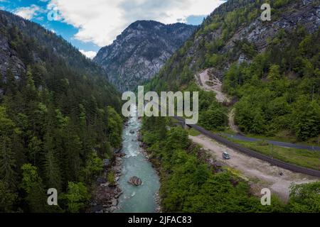 Drone aerial view of wild river Enns in cloudy weather in Gesause National Park near town of Admont in centre Austria. Visible long valley, clear blue Stock Photo