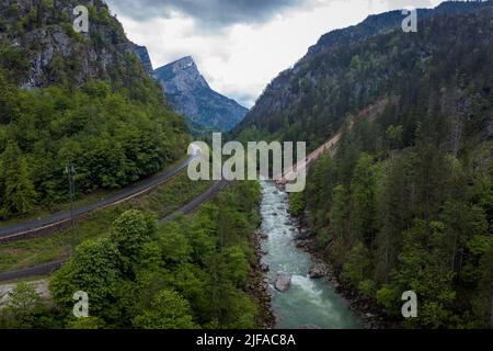 Drone aerial view of wild river Enns in cloudy weather in Gesause National Park near town of Admont in centre Austria. Visible long valley, clear blue Stock Photo