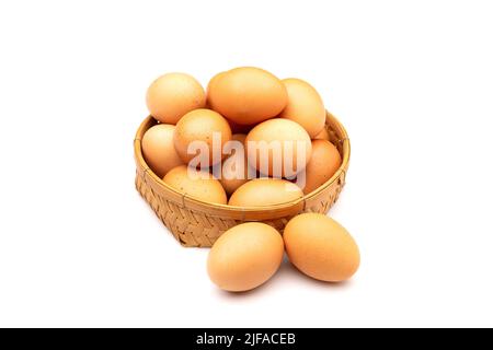 Chicken Eggs in basket isolated on white background Stock Photo