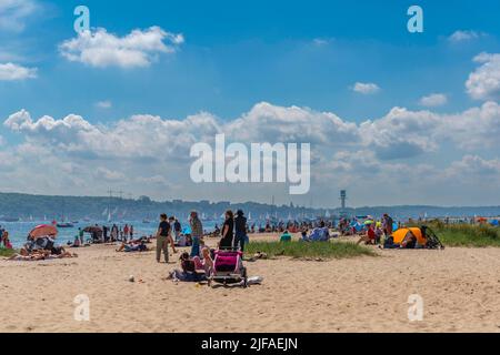 Falkenstein beach, spectators of the windjammer parade, leisure, bathing, parasol, children's cart, summer, blue sky, Friedrichsort lighthouse Stock Photo