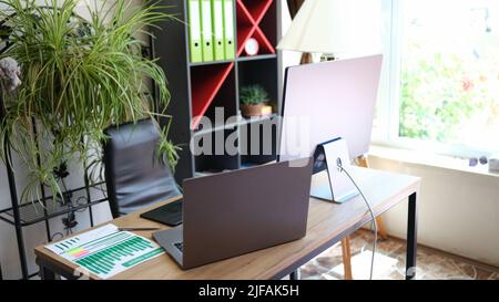 Comfortable office chair near table with modern computer Stock Photo