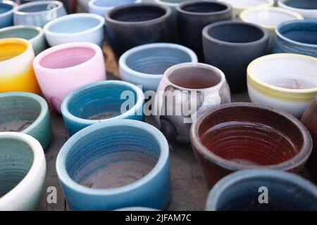 Old clay colorful pots on wooden floor Stock Photo