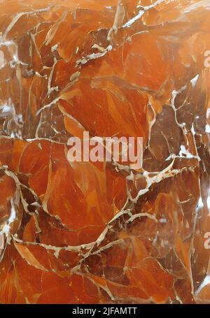 A vertical close-up orange-colored marble stone pattern great match for background and design Stock Photo