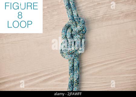 Above shot of hiking rope tied in a knot against a wooden background in  studio. Figure 8 knot, A knot for every situation. Strong rope to secure  safet Stock Photo - Alamy