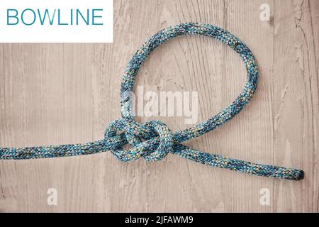 Above shot of hiking rope tied in a knot against a wooden background in  studio. Bowline knot. A knot for every situation. Strong rope to secure  safety Stock Photo - Alamy