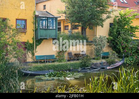 a sunken gondola in a picturesque canal in the town Frederiksværk, Denmark, June 28, 2022 Stock Photo