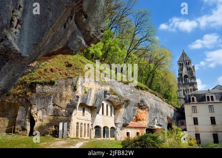 France, Dordogne, Brantome, Saint Pierre benedictine abbey, the ancient troglodyte dwellings and the caves nestled in the cliff and the bell tower of the abbey church (11th century) in the background Stock Photo