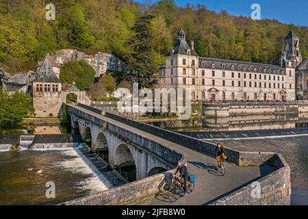 France, Dordogne, Brantome, cyclists traveling along the Flow Vélo cycle route crossing the Pont Coude (angled bridge) over Dronne River, Saint Pierre benedictine abbey in the background (aerial view) Stock Photo