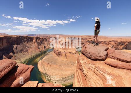 Adventurous Caucasian Woman at Horseshoe Bend in Page, Arizona, United States. Stock Photo