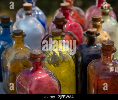 medieval historical reenactment - glass bottles with cork stopper with powder colors inside used to paint or to color clothes and leather Stock Photo