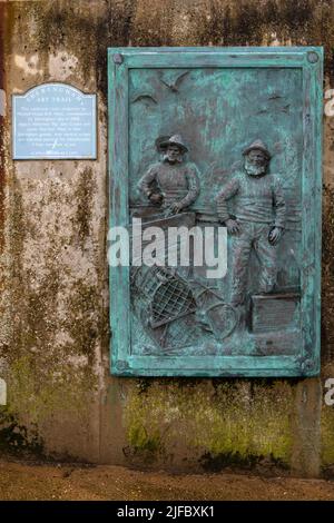 Sheringham, UK - May 16th 2022: Sculptured plaque of fishermen John Craske and James West, located on the promenade in the seaside town of Sheringham Stock Photo