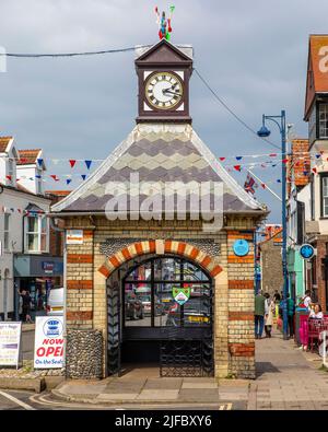 Sheringham, UK - May 16th 2022: Clock tower in the seaside town of Sheringham in Norfolk, UK. The construction was originally a water pump which suppl Stock Photo