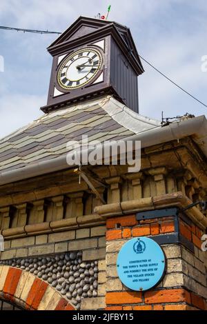 Sheringham, UK - May 16th 2022: Clock tower in the seaside town of Sheringham in Norfolk, UK. The construction was originally a water pump which suppl Stock Photo