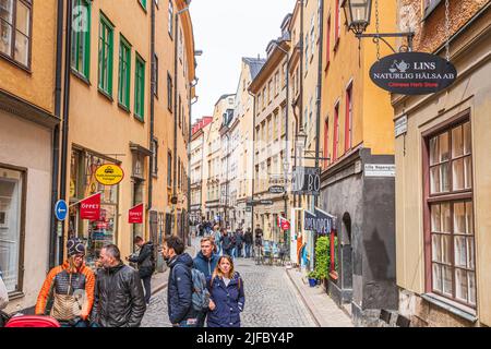 Shoppers and tourists in Österlånggatan in Gamla Stan (the old town) in Stockholm, Sweden Stock Photo