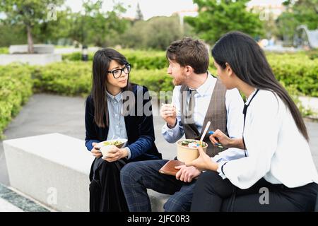 Happy business people having a lunch break outside office Stock Photo