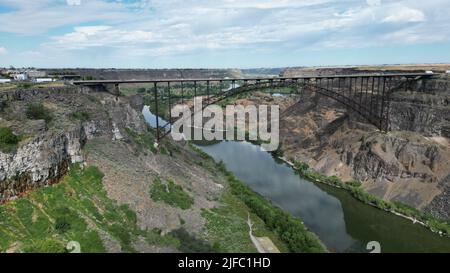 A view of a bridge over the river between the canyons Stock Photo