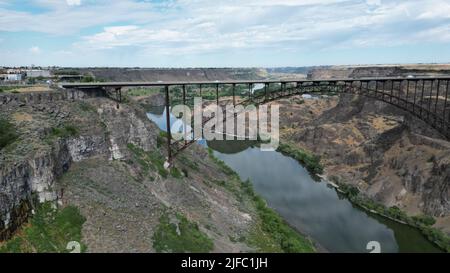 A view of a bridge over the river between the mountains Stock Photo