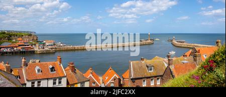 Panoramic view from the 199 steps, of the piers and lighthouses of Whitby Harbour in Whitby, North Yorkshire, UK. Stock Photo