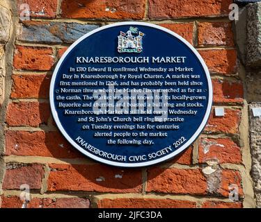 Knaresborough, UK - June 4th 2022: A plaque detailing the history of Knaresborough Market, located in the beautiful town of Knaresborough in North Yor Stock Photo