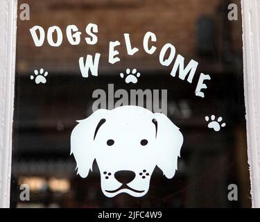 York, UK - June 6th 2022: Dogs Welcome sign in a shop window. Stock Photo