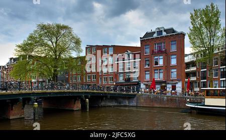 Amsterdam in spring under cloudy sky Stock Photo