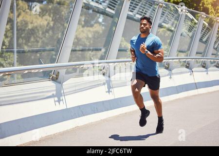 Mixed race man serious about his health. Hispanic male focused on his health while exercising outside. Athletic man doing cardio and training for a Stock Photo