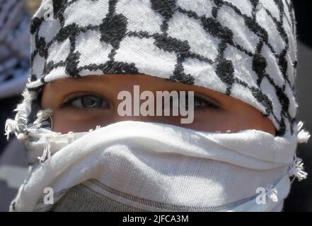 Nablus, West Bank, Palestine. 22nd June, 2022. A masked Palestinian protester seen, during the demonstration against Israeli settlements in the village of Kafr Qaddoum near the West Bank city of Nablus. (Credit Image: © Nasser Ishtayeh/SOPA Images via ZUMA Press Wire) Stock Photo