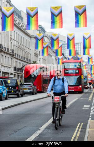 London, UK. 1 July 2022.  Rainbow flags hang overhead on Regent Street ahead of Pride in London.  Credit: Stephen Chung / Alamy Live News Stock Photo