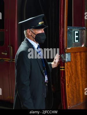 Pickering, UK - June 9th 2022: A Station Master on the platform at Pickering Railway Station in North Yorkshire, UK. Stock Photo