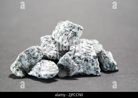 Granites are coarsely crystalline plutonic rocks (plutonites) rich in quartz and feldspar Stock Photo