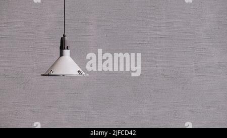 A hanging lamp against the gray wall Stock Photo