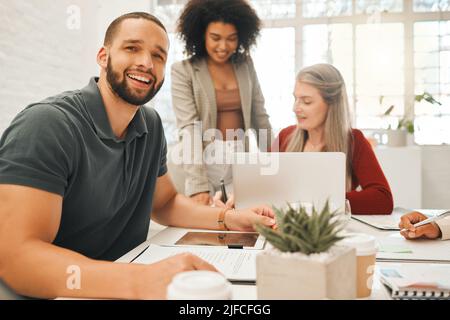 Handsome young businessman in a meeting. Businesspeople collaborate in a meeting. Portrait of a happy businessman working with colleagues. Architects Stock Photo
