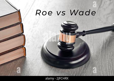 Roe versus Wade text. Law hammer and old books on wooden table. Stock Photo