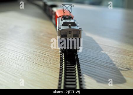 A soft focus of a model train (N gauge) engine with pantograph mechanism Stock Photo