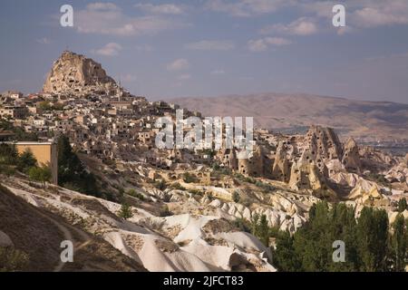 Uchisar village with rock-cut cave dwellings in the Pigeon valley near Goreme, Cappadocia region, Turkey. Stock Photo