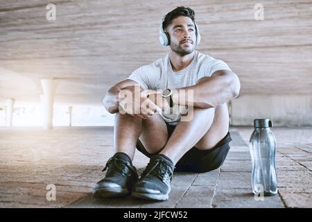 Serious athlete taking break from workout. Young man getting ready to workout. Serious athlete taking break from workout. Young man getting ready to Stock Photo