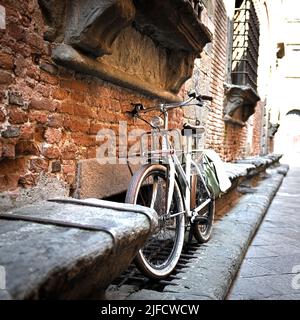 Vintage bicycle in a street of a Tuscan village, during the summer Stock Photo