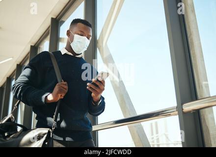 African American man using a cellphone while walking outside. African American man using a cellphone while walking outside. Stock Photo