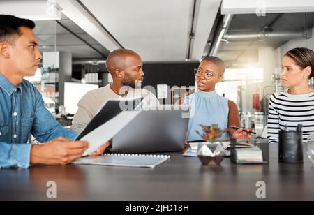Group of diverse businesspeople having a meeting in an office at work. Business professionals talking in an office. Young african american Stock Photo