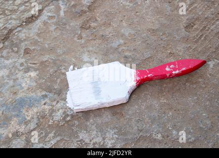 Close up paint brush on the cement floor Stock Photo