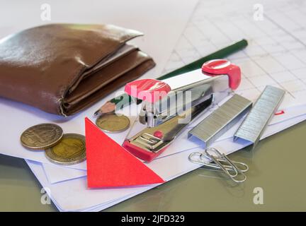 Stapler with staples wires on white paper in office Stock Photo