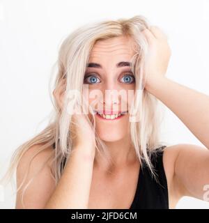 Blue-eyed blonde playing the fool at camera Stock Photo
