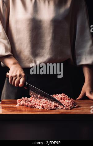 Chopped pork into meat filling, the traditional Chinese cuisine three fresh dumplings filling production - stock photo Stock Photo